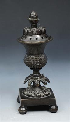 Lot 55 - A 19TH CENTURY BRONZE INCENSE BURNER AND COVER of thistle form on a square base with ball feet