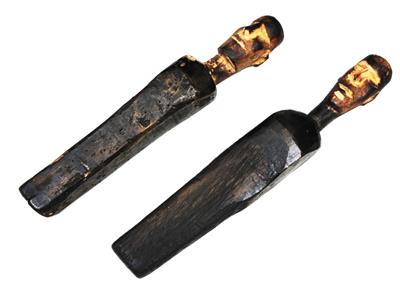 Lot 58 - A PAIR OF PRIMITIVE CARVED WOODEN MALE FIGURE HEADS of tapering form