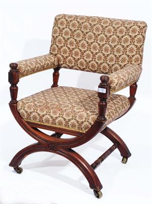 Lot 79 - A LATE VICTORIAN WALNUT FRAMED ARMCHAIR with inverted hoop and turned stretcher support on castors