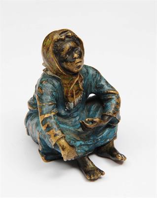 Lot 82 - A VIENNA BERGMAN COLD CAST BRONZE SEATED FIGURE of a girl in blue tunic