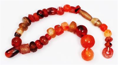 Lot 250 - A STRING OF ANCIENT INDIAN CORNELIAN AND STONE BEADS