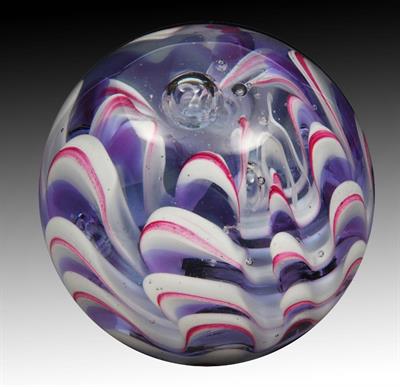 Lot 267 - A HEAVY GLASS PAPERWEIGHT with simulated wave decoration