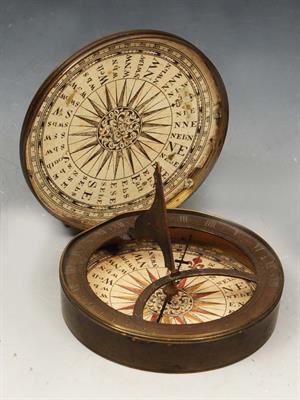 Lot 269 - AN 18TH CENTURY BRASS POCKET COMPASS with engraved paper dials and folding gnomon