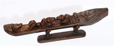 Lot 307 - A PAPUA NEW GUINEA MASSIM SOUL BOAT with four figures in a carved wooden boat on stand