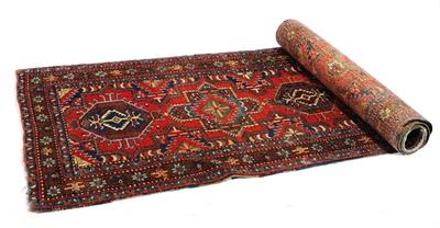 Lot 325 - A KARAJAR RUST GROUND RUNNER decorated a pattern of interlocking medallions within a multiple border