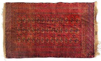 Lot 326 - A TURKOMAN WINE RED GROUND RUG decorated three rows of thirteen guls within a multiple border