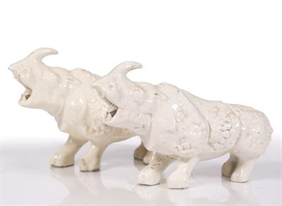Lot 34 - A pair of Chinese white glazed models of rhinoceroses
