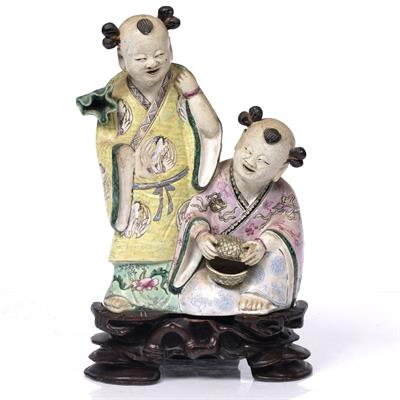 Lot 155 - A Chinese porcelain group of two boys