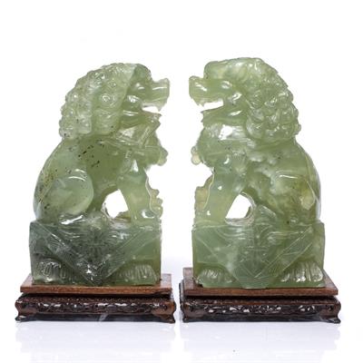 Lot 178 - A pair of Chinese carved green hardstone temple dogs