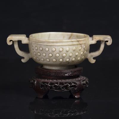 Lot 328 - A Chinese brown striated grey jade archaic bronze style two handled wine cup