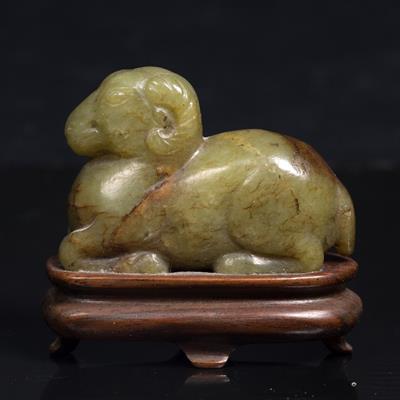 Lot 332 - A Chinese green and brown jade reclining ram