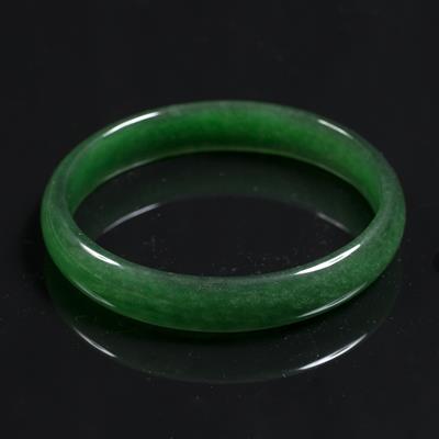 Lot 339 - A Chinese spinach jade bangle