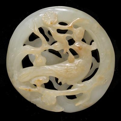 Lot 371 - A Chinese white and rust tinted jade pebble shaped pendant