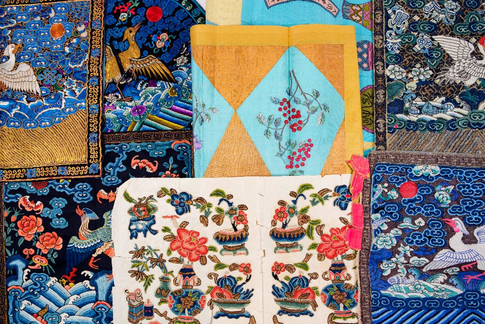 Lot 385 - A large collection of Chinese embroidered silks