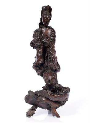 Lot 402 - A Chinese carved naturalistic wood model of Guanyin