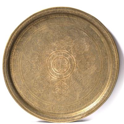 Lot 629 - A Qajar engraved brass round tray