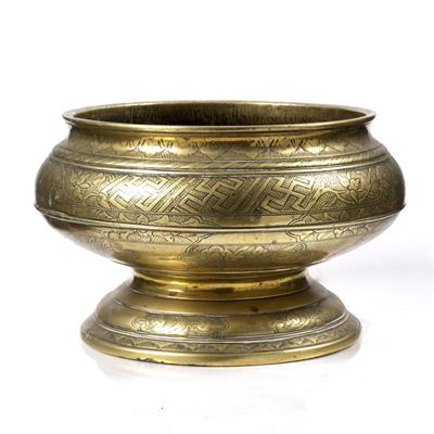 Lot 677 - A Javanese brass pedestal bowl