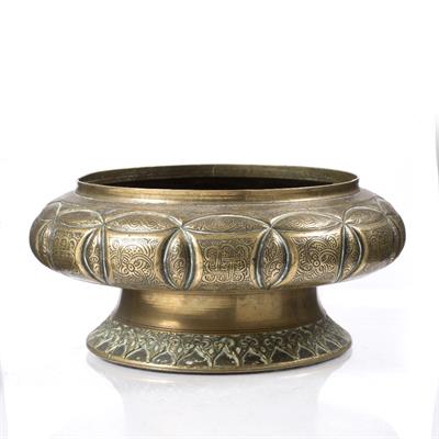 Lot 684 - A Persian engraved brass pedestal bowl