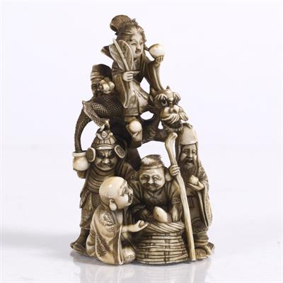 Lot 788 - A Japanese ivory okimono carved as a pyramid depicting the Shichifukin