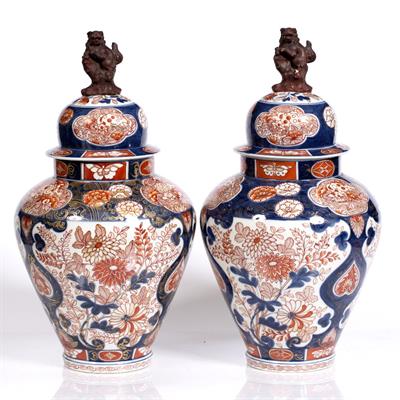 Lot 824 - A pair of Japanese Imari vases and covers