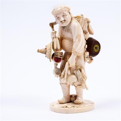 Lot 956 - A Japanese ivory okimono of an itinerant vendor or street entertainer