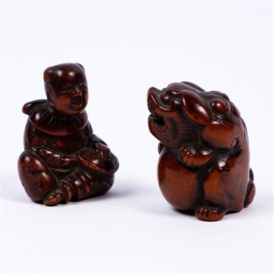 Lot 960 - A Japanese wood netsuke of a seated shi shi and ball