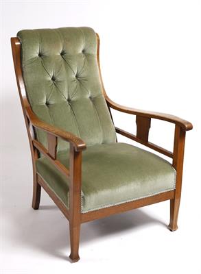 Lot 21 - An Arts & Crafts oak framed armchair