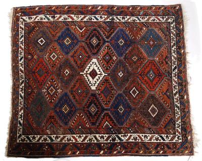 Lot 65 - A Kazak rust ground rug