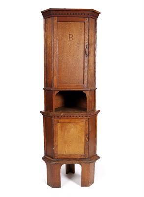 Lot 77 - An Arts and Crafts oak corner cupboard