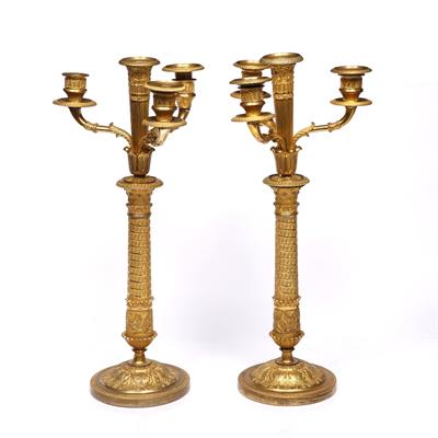 Lot 100 - A pair of French Empire gilt metal three branch candelabra
