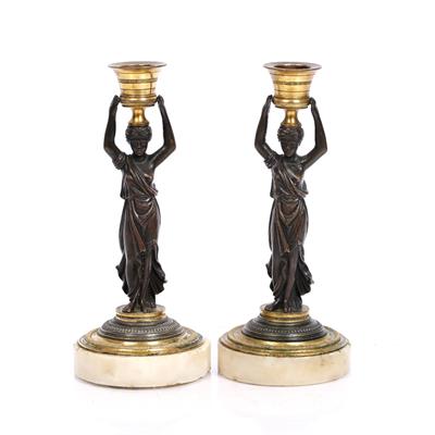 Lot 101 - A pair of Regency bronze candlesticks