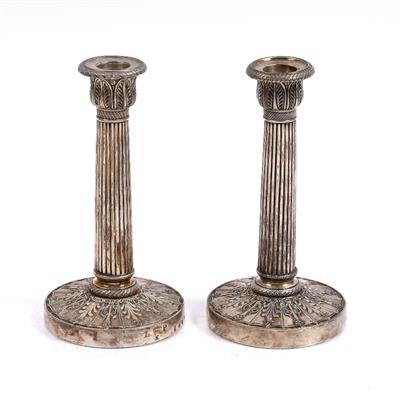 Lot 102 - A pair of French Empire silvered bronze candlesticks