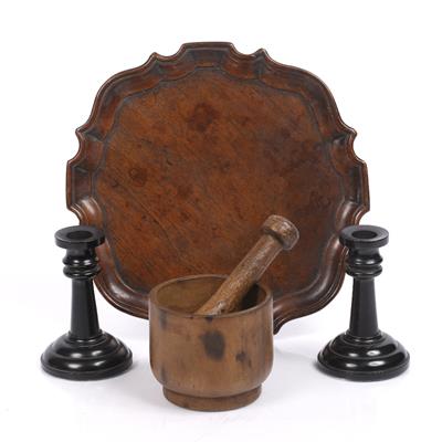 Lot 148 - A pair of ebony short candlesticks