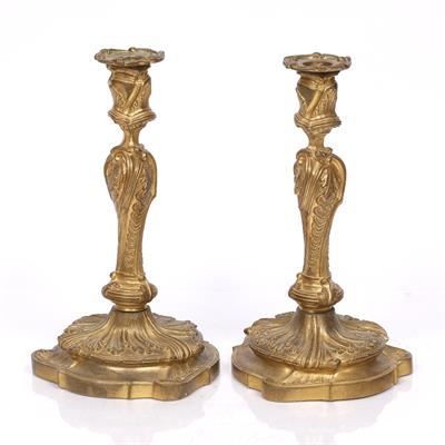 Lot 246 - A pair of French ormolu rococo candlesticks