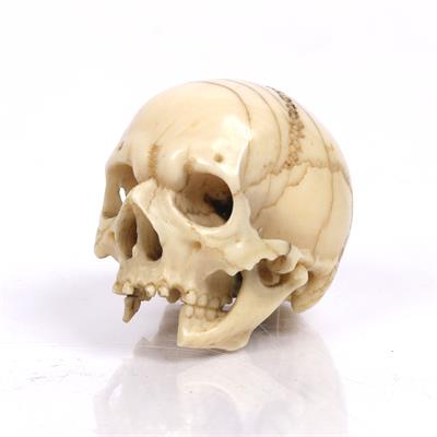 Lot 394 - An ivory miniature carving of a skull