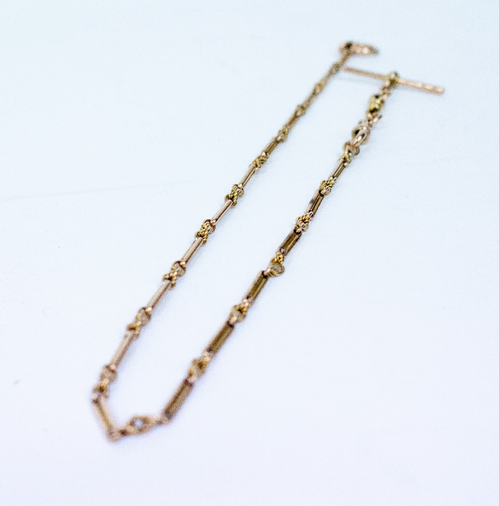 Lot 402 - A 15CT YELLOW GOLD LADIES WATCH CHAIN