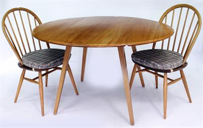 Lot 557 - AN ERCOL LIGHT ELM AND BEECHWOOD DROP LEAF DINING TABLE