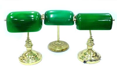 Lot 747 - A GROUP OF THREE BRASS GREEN GLASS SHADED DESK LAMPS