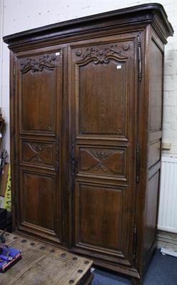 Lot 824 - A CONTINENTAL OAK TWO DOOR ARMOIRE