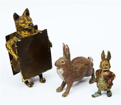 Lot 9 - A BERGMAN STYLE BRONZE COLD PAINTED SCULPTURE of a standing fox carrying a notice board and two smal
