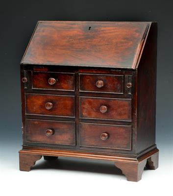Lot 15 - A GEORGE III APPRENTICE MINIATURE MAHOGANY BUREAU with fitted interior and six drawers
