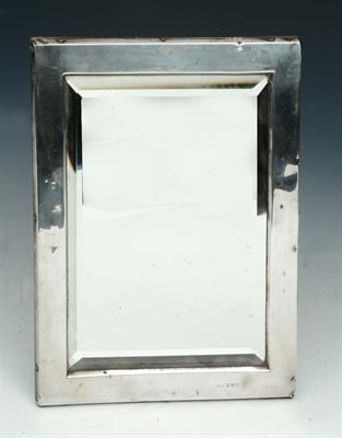 Lot 29 - A SILVER RECTANGULAR MIRROR with bevelled glass and strut support