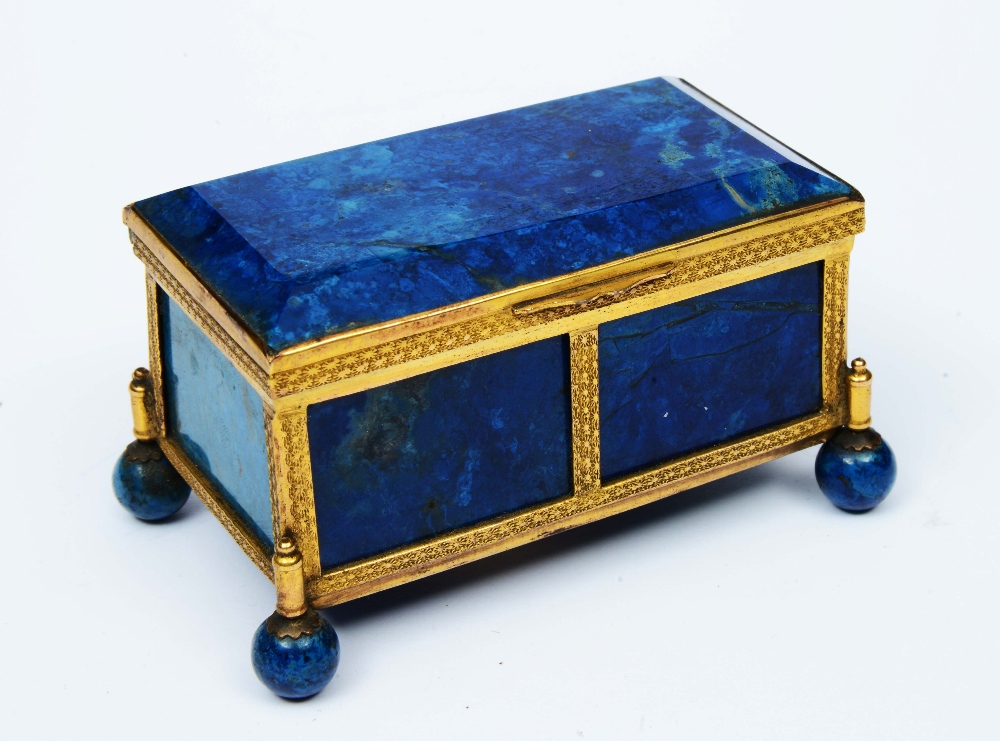 Lot 49 - A FRENCH LAPIS LAZULI AND GILT METAL MOUNTED RECTANGULAR MINIATURE CASKET on ball feet