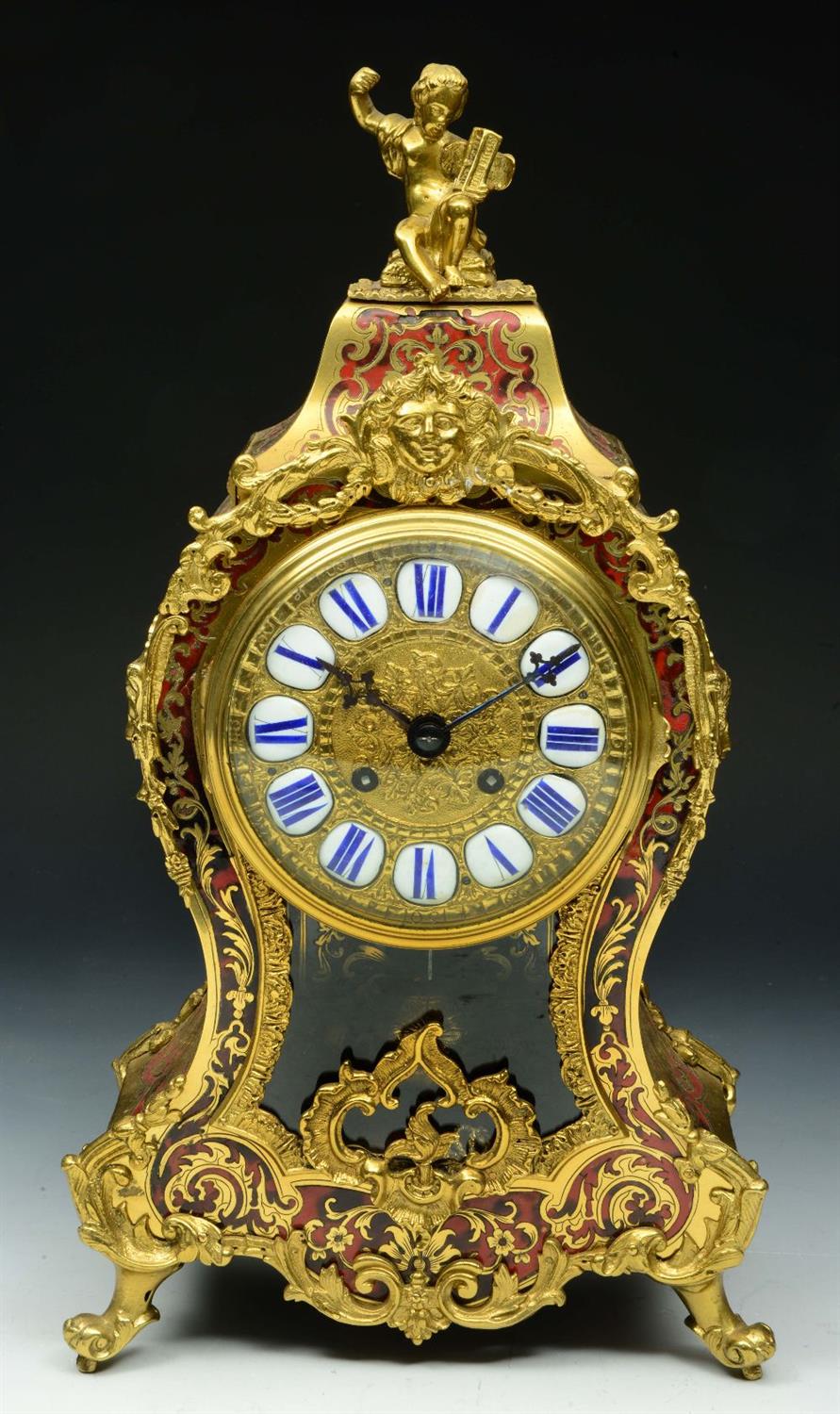 Lot 115 - A FRENCH RED TORTOISESHELL AND BRASS INLAID CLOCK with blue enamel numerals and rococo scroll and ch