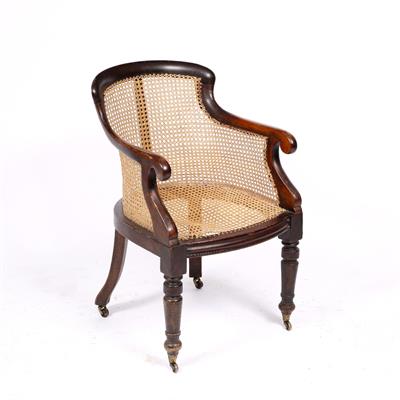 Lot 172 - A 19TH CENTURY MAHOGANY BERGERE LIBRARY ARMCHAIR with cane seat and back and ring turned forelegs