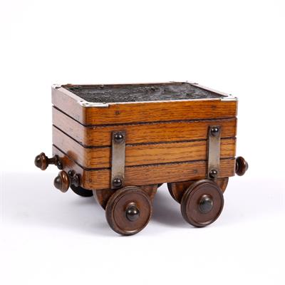 Lot 184 - A LATE VICTORIAN OAK AND SILVER MOUNTED NOVELTY CIGAR BOX in the form of a steam engine tender with