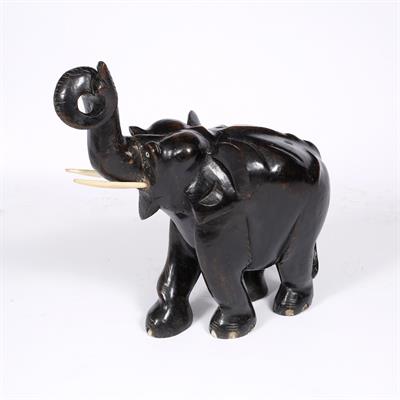 Lot 185 - A LARGE INDIAN CARVED WOOD AND EBONISED MODEL of an elephant with upraised trunk