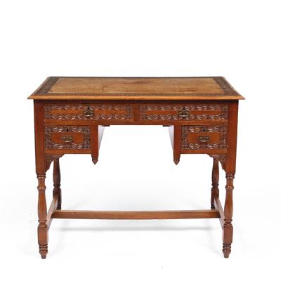 Lot 211 - AN AESTHETIC MOVEMENT CARVED WALNUT KNEEHOLE DESK with two short and two deep drawers on ring turned