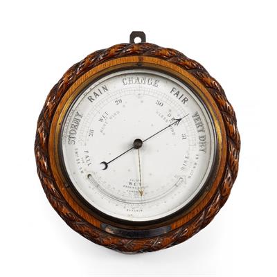 Lot 221 - A VICTORIAN ANEROID BAROMETER AND THERMOMETER in a circular rope carved oak case with presentation p