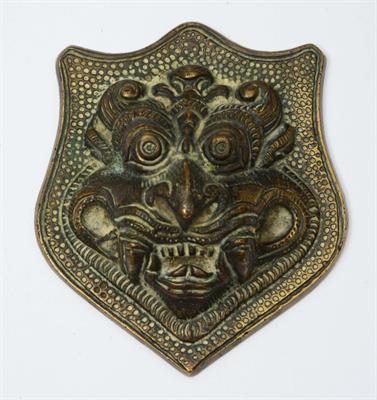 Lot 232 - A SOUTH INDIAN METAL 'MAKARA TORANA' PLAQUE of shield form